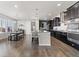 Spacious kitchen with dark cabinets, stainless steel appliances, and a center island with bar seating at 3745 Spanish Oaks Trl, Castle Rock, CO 80108