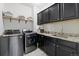 Well-equipped laundry room with modern washer, dryer, storage cabinets, and granite countertops offers convenience and style at 3745 Spanish Oaks Trl, Castle Rock, CO 80108