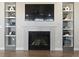 Cozy living room with a tile fireplace and built-in shelving on either side at 3745 Spanish Oaks Trl, Castle Rock, CO 80108