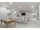 Bright living room has neutral decor, a foosball table, and comfortable seating, perfect for entertaining guests or relaxing with Gathering at 3745 Spanish Oaks Trl, Castle Rock, CO 80108