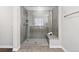 Modern bathroom features a glass enclosed shower with gray tile and a built-in bench for a spa-like experience at 3745 Spanish Oaks Trl, Castle Rock, CO 80108