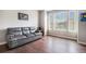 Sitting room bathed in natural light with a grey couch and hardwood floors at 3745 Spanish Oaks Trl, Castle Rock, CO 80108