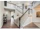 Grand staircase with white railing and carpeted steps leading to the second floor at 3745 Spanish Oaks Trl, Castle Rock, CO 80108