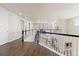 Upstairs hallway with dark wood floors, white doors, and black railings at 3745 Spanish Oaks Trl, Castle Rock, CO 80108