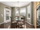 Cozy breakfast nook with bay windows, a glass table, and built-in cabinetry at 11761 Lewiston St, Commerce City, CO 80022