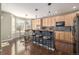 Modern kitchen featuring stainless steel appliances, wooden cabinets, and breakfast bar at 11761 Lewiston St, Commerce City, CO 80022