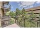 View from balcony with metal railing overlooking trees and a landscaped walkway at 9079 E Panorama Cir # 309, Englewood, CO 80112