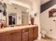 Bright bathroom features double sinks, a large mirror, and tile countertops at 9079 E Panorama Cir # 309, Englewood, CO 80112