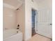 Clean bathroom with white tile, tub, and shower; featuring modern fixtures at 9079 E Panorama Cir # 309, Englewood, CO 80112