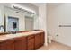 Bathroom with double sinks, wood cabinets, tile countertops and tiled floor at 9079 E Panorama Cir # 309, Englewood, CO 80112