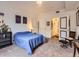 Well-lit bedroom featuring neutral carpet and minimalistic furniture with adjacent bathroom access at 9079 E Panorama Cir # 309, Englewood, CO 80112