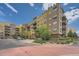 Beautiful condo building with balconies, landscaping, and a well-maintained parking area at 9079 E Panorama Cir # 309, Englewood, CO 80112