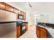 Kitchen with wood cabinets, granite counters, stainless steel refrigerator and range at 9079 E Panorama Cir # 309, Englewood, CO 80112