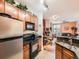 Efficient kitchen setup featuring stainless steel appliances and a convenient breakfast bar that opens to the living room at 9079 E Panorama Cir # 309, Englewood, CO 80112