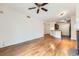Bright living room features hardwood floors, open layout to kitchen, and ceiling fan at 9079 E Panorama Cir # 309, Englewood, CO 80112