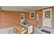 Charming back patio with an outdoor dining set, surrounded by a brick exterior and neat landscaping at 6620 S Foresthill St, Littleton, CO 80120