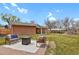 Spacious backyard featuring a patio area, lush green lawn, and mature trees, perfect for outdoor living at 6620 S Foresthill St, Littleton, CO 80120