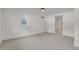 Basement featuring neutral carpet and crisp white walls leading to an adjacent room, offering versatile living space at 6620 S Foresthill St, Littleton, CO 80120
