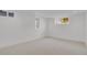 Bright basement space with neutral carpet, natural light, and crisp white walls offers versatile living at 6620 S Foresthill St, Littleton, CO 80120