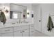 Bathroom with a large mirror and vanity with marble countertops, alongside modern fixtures at 6620 S Foresthill St, Littleton, CO 80120