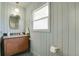 Charming bathroom with vintage-style vanity, and light green beadboard adding a touch of warmth and character at 6620 S Foresthill St, Littleton, CO 80120