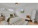 Bright bedroom featuring a comfortable bed, stylish rug, and large windows offering pleasant outdoor views at 6620 S Foresthill St, Littleton, CO 80120
