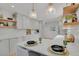 Elegant kitchen with white cabinetry, stainless steel appliances, and a breakfast bar at 6620 S Foresthill St, Littleton, CO 80120