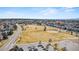 Aerial view of the property with the neighborhood park, baseball field, and walking paths at 6445 S Telluride St, Aurora, CO 80016