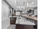 Basement bar area with stone countertops, a sink, a microwave, custom cabinets, and modern pendant lighting at 6445 S Telluride St, Aurora, CO 80016