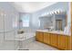 Light-filled bathroom with double vanity, soaking tub, separate shower, and tile flooring at 6445 S Telluride St, Aurora, CO 80016