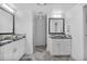 Modern bathroom with dual vanities, granite countertops, and stylish herringbone tile floors at 6445 S Telluride St, Aurora, CO 80016