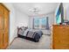 Bedroom featuring neutral carpet, a ceiling fan, natural light, and a wood dresser with a TV on top at 6445 S Telluride St, Aurora, CO 80016