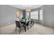 Formal dining room with modern chandelier, black dining set, and large windows at 6445 S Telluride St, Aurora, CO 80016