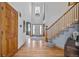 Bright foyer with hardwood floors, staircase, and a soaring ceiling at 6445 S Telluride St, Aurora, CO 80016