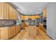 Well-lit kitchen featuring wooden cabinets, stainless steel appliances, and a functional center island at 6445 S Telluride St, Aurora, CO 80016