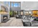 Bright living room with fireplace, tall windows, and a comfortable sectional sofa at 6445 S Telluride St, Aurora, CO 80016