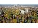A cityscape aerial view featuring the high-rise, surrounded by tree coverage and a vibrant downtown skyline in the distance at 1200 N Humboldt St # 101, Denver, CO 80218