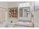 Light and bright bathroom with updated fixtures, vanity, and cute wall art at 1200 N Humboldt St # 101, Denver, CO 80218
