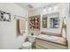 Bright bathroom featuring a granite-topped vanity, decorative mirror, and quilt art, creating a fresh and appealing atmosphere at 1200 N Humboldt St # 101, Denver, CO 80218