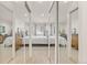 Bright bedroom with mirrored closet doors, modern bed, and neutral carpet at 1200 N Humboldt St # 101, Denver, CO 80218