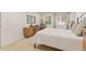 Sunlit bedroom featuring a wrought iron bed frame, neutral carpet, dresser, and a bright abstract painting at 1200 N Humboldt St # 101, Denver, CO 80218