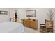 Bright bedroom featuring a vintage wood dresser with mirror and wrought iron bed frame at 1200 N Humboldt St # 101, Denver, CO 80218
