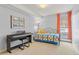 Cozy bedroom with keyboard, window and colorful patchwork quilt at 1200 N Humboldt St # 101, Denver, CO 80218