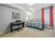 Serene bedroom with carpet, digital piano, and large window with light-blocking curtains at 1200 N Humboldt St # 101, Denver, CO 80218