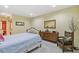 Bedroom features a comfortable bed, dresser, chair, and neutral decor at 1200 N Humboldt St # 101, Denver, CO 80218