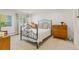 Well-lit bedroom with a wrought iron bed frame, plush carpet, and neutral décor, and built in dressers at 1200 N Humboldt St # 101, Denver, CO 80218