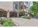 Charming building entrance with brick arches, landscaped garden, and secure gate, creating a welcoming and secure environment at 1200 N Humboldt St # 101, Denver, CO 80218