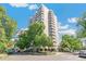 Elegant high-rise residence showcasing a symmetrical facade, multiple balconies, and beautiful landscaping in an urban environment at 1200 N Humboldt St # 101, Denver, CO 80218