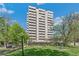 A high-rise building with multiple floors and balconies, situated near a park, offering an urban living experience at 1200 N Humboldt St # 101, Denver, CO 80218