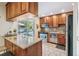 Well-lit kitchen with wood cabinets, granite countertops, stainless steel appliances, and a breakfast bar at 1200 N Humboldt St # 101, Denver, CO 80218